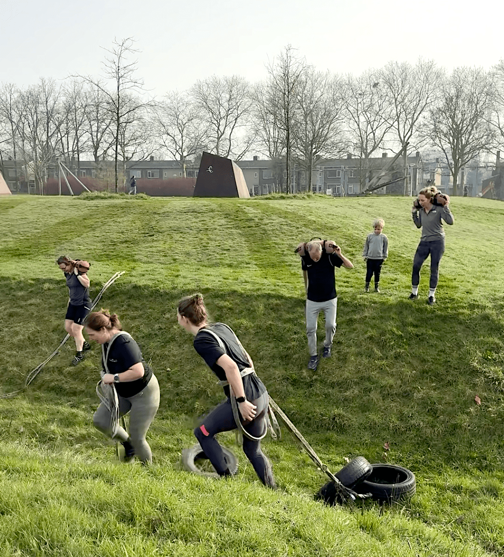 Banden slepen Deelnemers aan Heavy Duty Bootcamp in Nijmegen slepen autobanden door het park